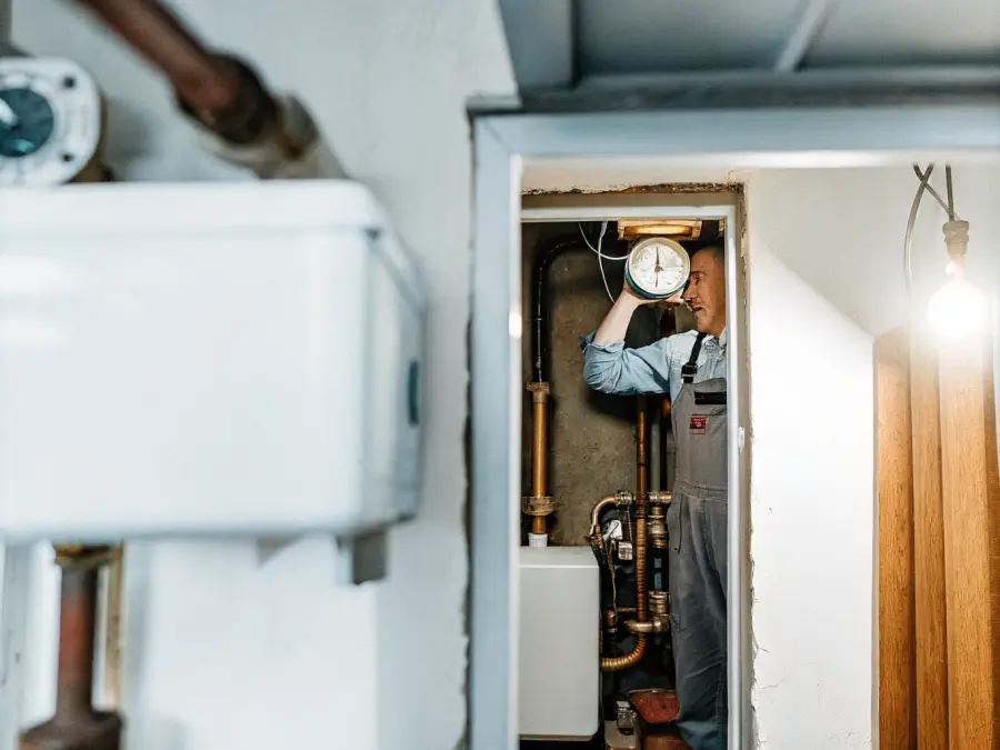 Copperline technician checking the pressure gauge on a home heating boiler