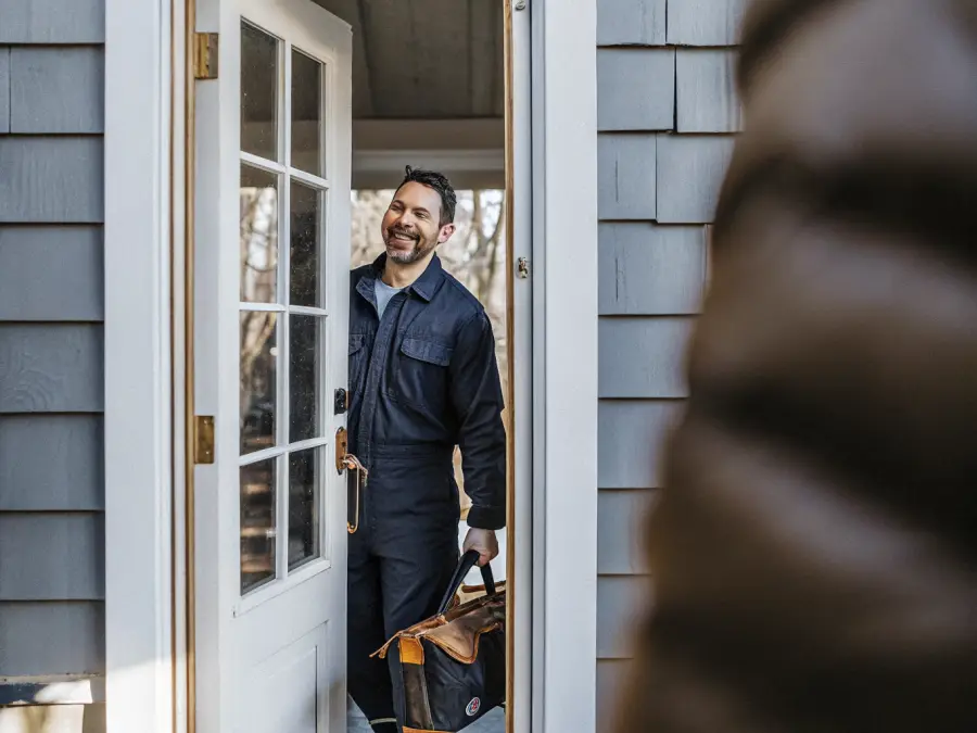 Copperline technician greeting a homeowner at the front door